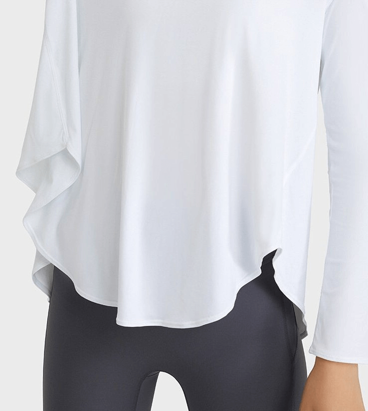 Stylish loose women's white top with long sleeves and V-neckline, designed for yoga comfort with breathable, quick-dry fabric.